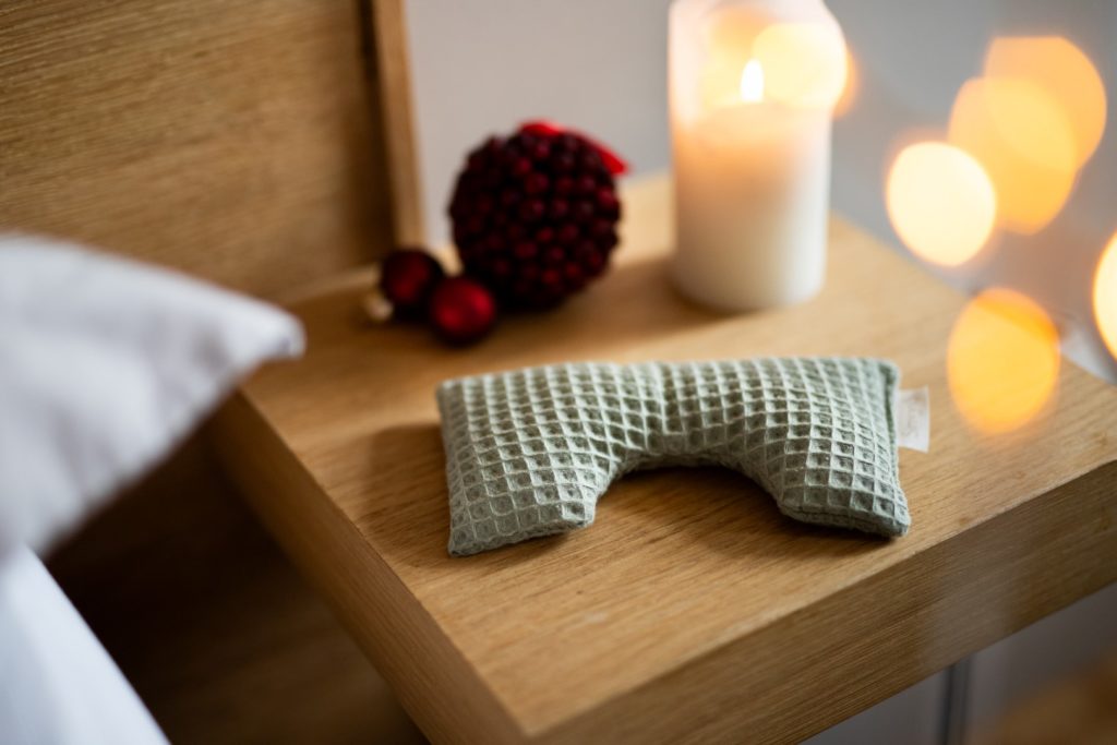 Masque de sommeil vert sur table en bois.